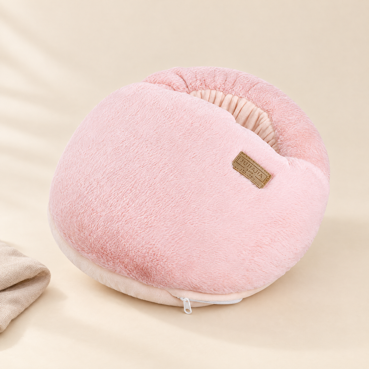 Plush heated foot warmer in pink on cream background