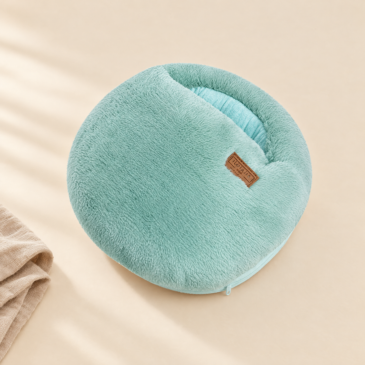 Plush heated foot warmer in mint green on cream background